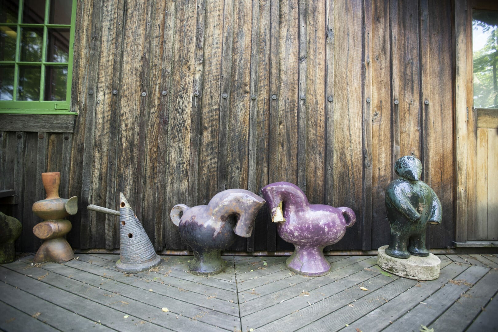 ceramic sculptures in front of wooden wall