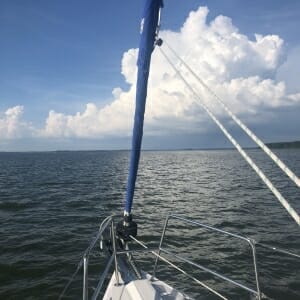 view from bow of boat, all water with a few white clouds