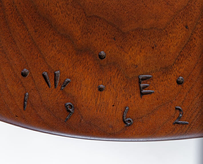 detail of wood surface with initials W. E. and 1962 carves into the surface