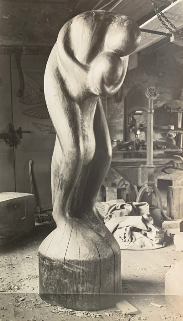 wood sculpture of two figures embracing