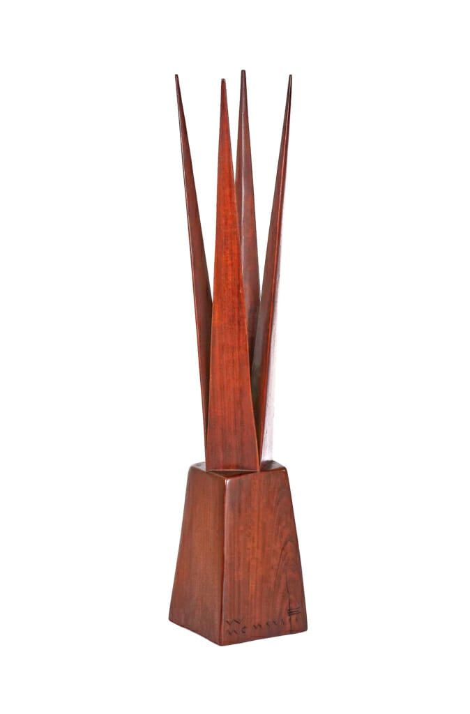 wood lamp with square base and bulb nested in four tall wood spires.