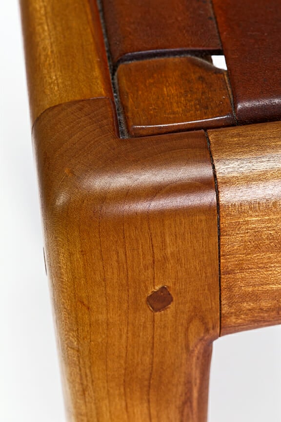 corner of chair seat where it where it meets leg showing mortise and tenon joint with squarish dowel