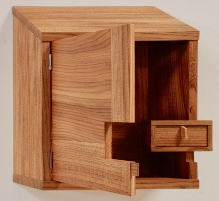 wood wall cabinet with inset drawer notched into door
