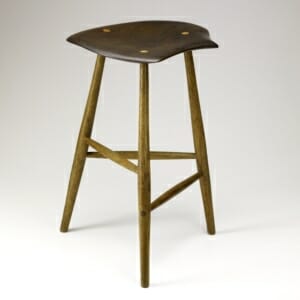 wooden three legged stool with irregular free-form shaped seat