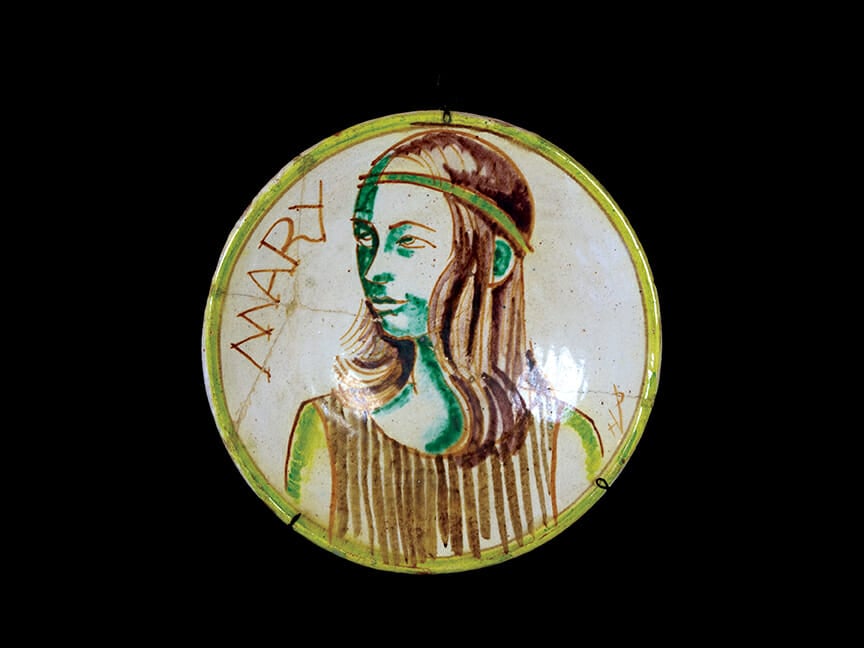ceramic plate with portrait on girl with shoulder length hair and headband. Text on plate reads: Mary