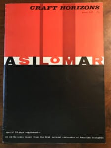 booklet lays on a wooden desktop. It has a bold cover design with solid red and black color fields and say "Asilomar" across the center.
