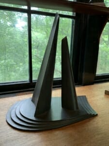 model of monument on a wood surface in front of a window
