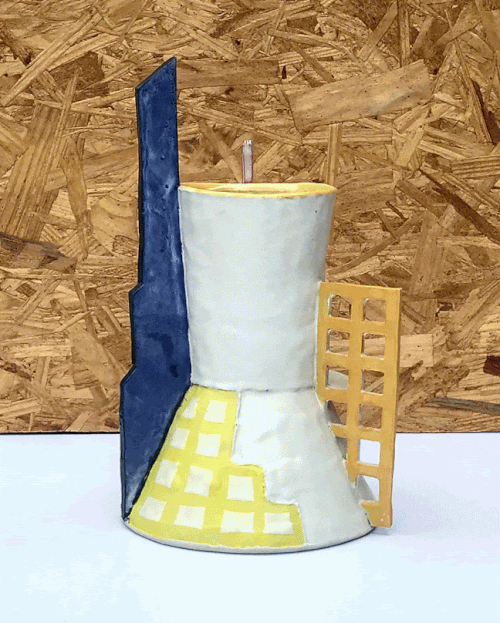ceramic vessel or white porcelain with a tall blue form on left, and yellow grid on right and a painted yellow grid on the base