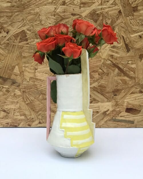 small vase with painted yellow lines, tall yellow "chimney" and pale reddish pink ladder-like handle