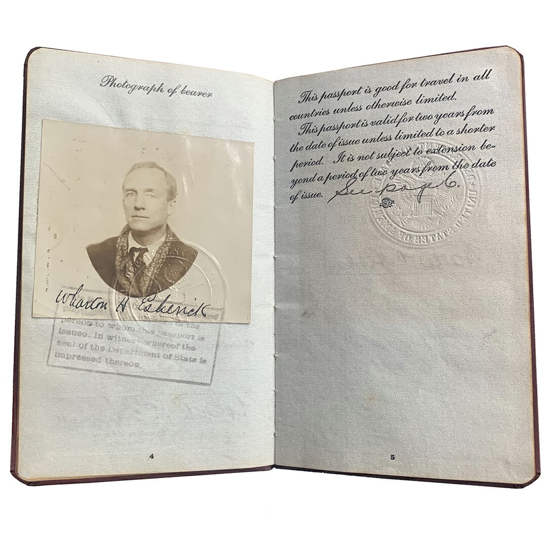 open passport booklet shows photo of Esherick wearing winter coat and fancy scarf, a stamp underneath, and passport text on the right.