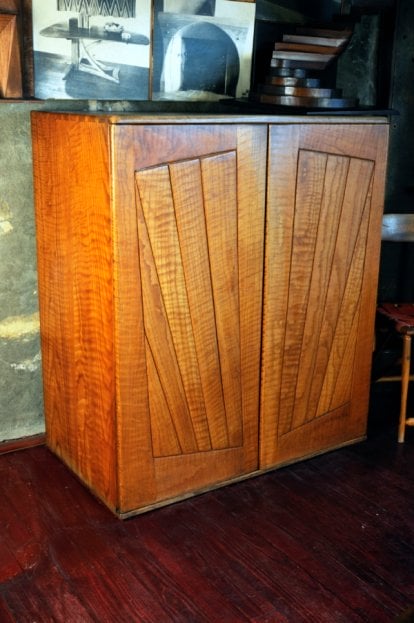 wood cabinet with radial patterned boards on the doors.