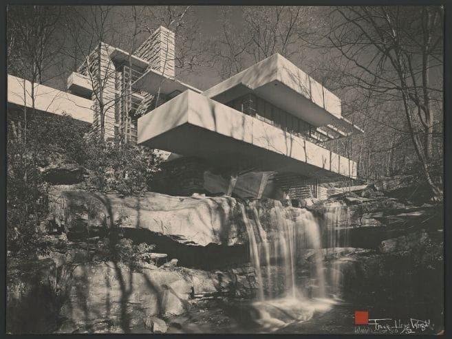 Black and white photo of Fallingwater, a geometric home built into a waterfall to look as if it is part of the landscape