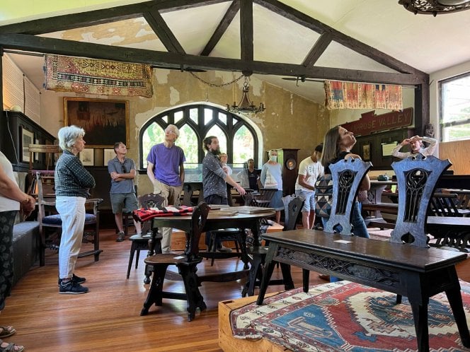 WEM volunteers and staff inside the Rose Valley Museum looking at the furniture collection